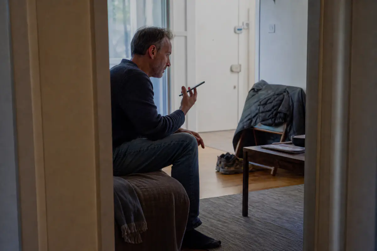 Man in his mid-50s preparing a thoughtful dating profile at home