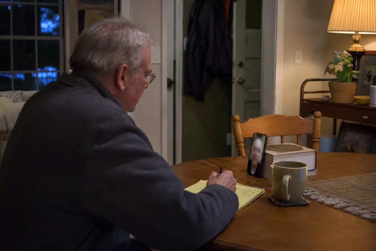 Adult over 60 preparing for a short video check before an in-person date